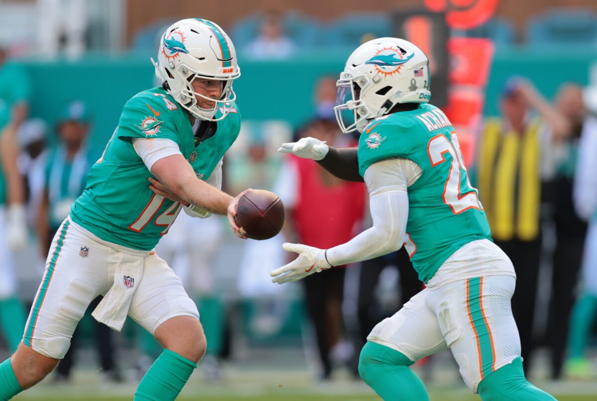 Dec 28, 2025; Miami Gardens, Florida, USA; Miami Dolphins quarterback Quinn Ewers (14) hands the ball off to running back De'Von Achane (28) during the third quarter against the Tampa Bay Buccaneers at Hard Rock Stadium. Mandatory Credit: Sam Navarro-Imagn Images