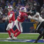 Buffalo Bills quarterback Josh Allen looks for an open receiver during second half action against the Philadelphia Eagles at Highmark Stadium in Orchard Park on Dec. 28, 2025. He ends up gettig sacked by an Eagles player who came running up the left side.