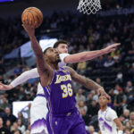 Dec 18, 2025; Salt Lake City, Utah, USA; Los Angeles Lakers guard Marcus Smart (36) shoots against Utah Jazz center Jusuf Nurkic (30) during the first quarter at Delta Center.