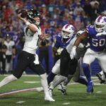 Jaguars quarterback Trevor Lawrence was pressured by the Bills defense breaking through the Jaguars offense line during the second half at Highmark Stadium in Orchard Park on Sept. 23, 2024. Closing in on Lawrence are Bills DaQuan Jones and Greg Rousseau.