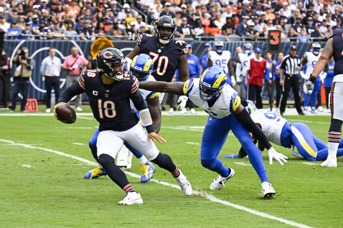 Sep 29, 2024; Chicago, Illinois, USA; Los Angeles Rams linebacker Jared Verse (8) chases Chicago Bears quarterback Caleb Williams (18) during the first half at Soldier Field. Mandatory Credit: Matt Marton-Imagn Images