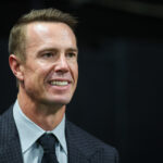 Oct 3, 2024; Atlanta, Georgia, USA; Former Atlanta Falcons quarterback Matt Ryan (2) on the sideline before being inducted in the team’s ring of honor at halftime of a game against the Tampa Bay Buccaneers at Mercedes-Benz Stadium. Mandatory Credit: Brett Davis-Imagn Images