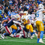 Dec 28, 2024; Foxborough, Massachusetts, USA; Los Angeles Chargers running back J.K. Dobbins (27) runs the ball against the New England Patriots in the first half at Gillette Stadium. Mandatory Credit: David Butler II-Imagn Images