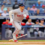 Sep 30, 2025; Bronx, New York, USA; Boston Red Sox third base Alex Bregman (2) hits a single during the first inning against the New York Yankees during game one of the Wildcard round for the 2025 MLB playoffs at Yankee Stadium. Mandatory Credit: Brad Penner-Imagn Images