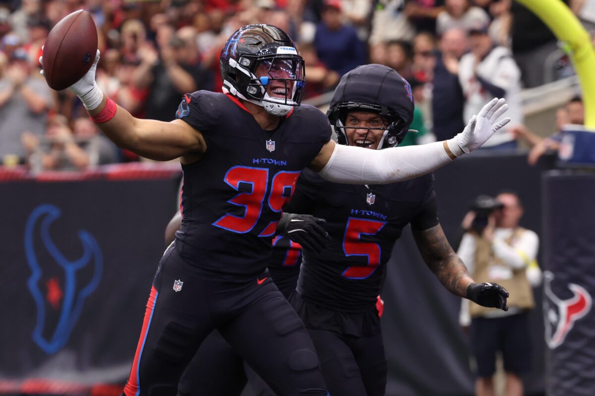 Jan 4, 2026; Houston, Texas, USA; Houston Texans linebacker Henry To'oto'o (39) reacts with safety Jalen Pitre (5) after a fumble recovery against the Indianapolis Colts during the first half at NRG Stadium. Mandatory Credit: Troy Taormina-Imagn Images
