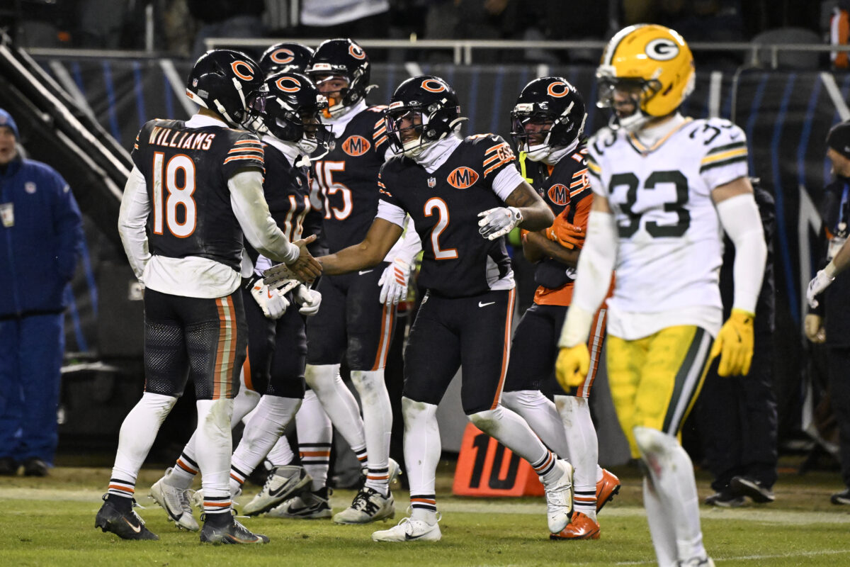Jan 10, 2026; Chicago, IL, USA; Chicago Bears quarterback Caleb Williams (18) and wide receiver DJ Moore (2) react after hooking up on the eventually game winning touchdown against the Green Bay Packers during the second half of an NFC Wild Card Round game at Soldier Field. Mandatory Credit: Matt Marton-Imagn Images