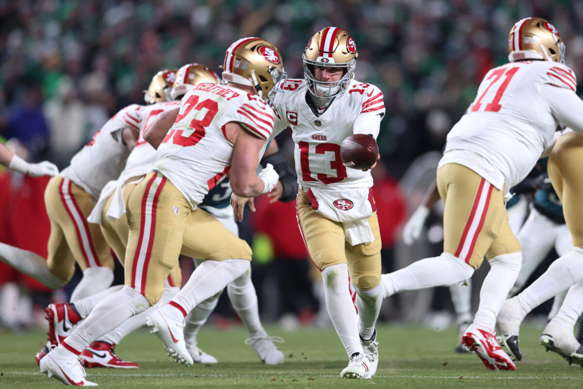 Jan 11, 2026; Philadelphia, PA, USA; San Francisco 49ers quarterback Brock Purdy (13) hands off the ball to running back Christian McCaffrey (23) against the Philadelphia Eagles during the second quarter in an NFC Wild Card Round game at Lincoln Financial Field. Mandatory Credit: Bill Streicher-Imagn Images