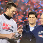 Jan 22, 2017; Foxborough, MA, USA; New England Patriots head coach Bill Belichick (R) hands the Lamar Hunt AFC championship trophy to Patriots quarterback Tom Brady (L) on the victory podium after the Patriots defeated the Pittsburgh Steelers in the 2017 AFC Championship Game at Gillette Stadium. Mandatory Credit: Geoff Burke-USA TODAY Sports