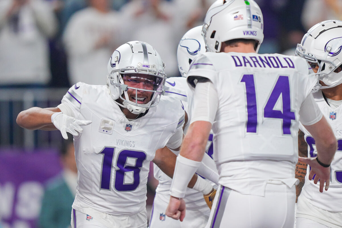 Dec 16, 2024; Minneapolis, Minnesota, USA; Minnesota Vikings wide receiver Justin Jefferson (18) celebrates his touchdown with quarterback Sam Darnold (14) against the Chicago Bears in the first quarter at U.S. Bank Stadium. Mandatory Credit: Brad Rempel-Imagn Images