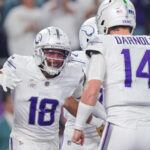 Dec 16, 2024; Minneapolis, Minnesota, USA; Minnesota Vikings wide receiver Justin Jefferson (18) celebrates his touchdown with quarterback Sam Darnold (14) against the Chicago Bears in the first quarter at U.S. Bank Stadium. Mandatory Credit: Brad Rempel-Imagn Images